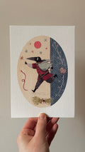'The Lover' print held in a hand: an oval with a beaked figure in a red coat striding past a red sun