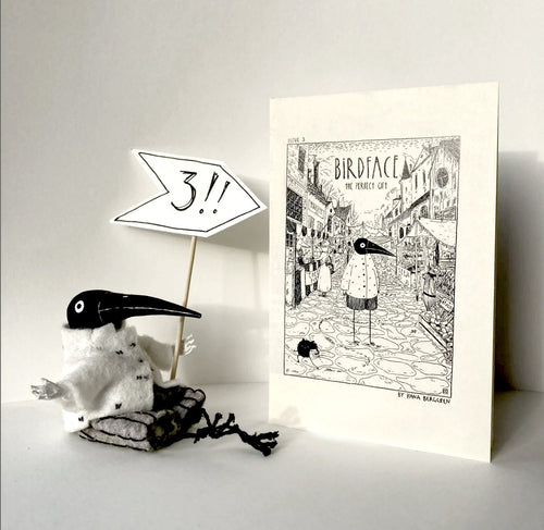 "Birdface: Issue 3" zine beside a small Birdface figure holding a sign that reads "3!"