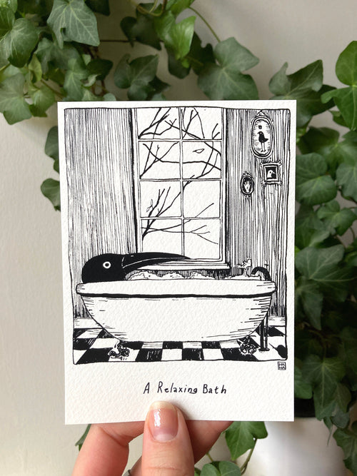 "A Relaxing Bath" print held in a hand: Birdface, a black bird-headed figure, in a bathtub by a window
