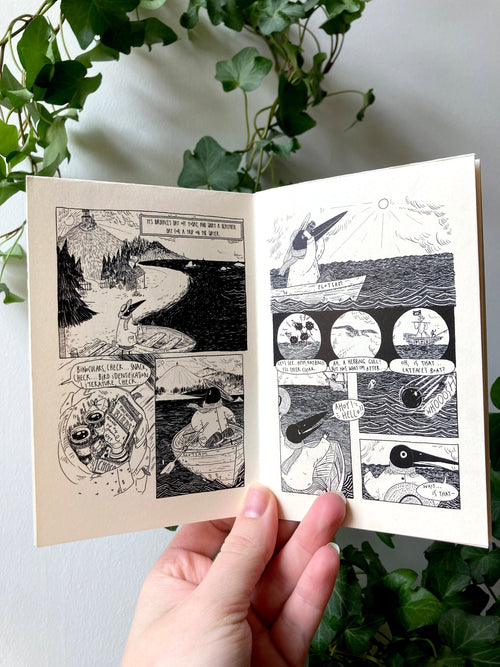 The zine held open in front of ivy: black and white comic pages of Birdface's day off