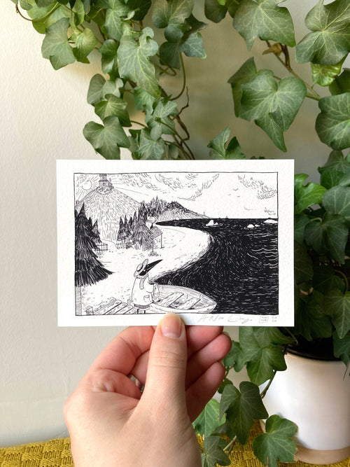 "A Nice Day" print held in a hand: ink drawing of Birdface on a path down to the sea, hills and a mountain behind