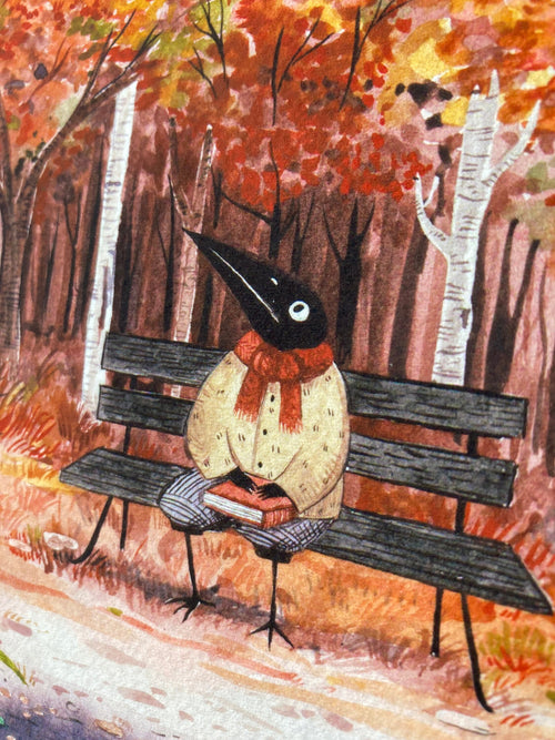 Close-up: Birdface, a bird-headed figure in a yellow jumper, rests on the bench with his book among birches