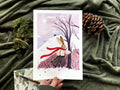 "Snow Rabbit" print on green fabric with a pine cone and moss: a rabbit in a red scarf by a bare tree in snow