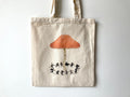 "Faerie Ring" tote bag: a cream cotton tote with an orange mushroom and a ring of dancing black figures