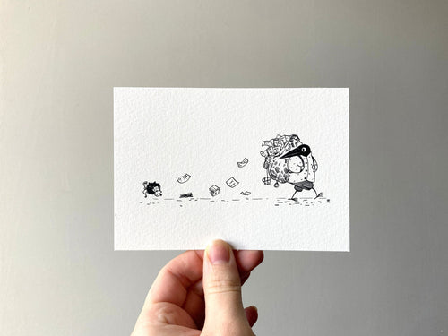 The print held in a hand, showing the white paper and the trail of dropped belongings