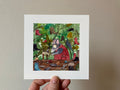 "The Boot Beast" print held in a hand: a creature at a cobbler's bench inside a leafy bush hung with boots